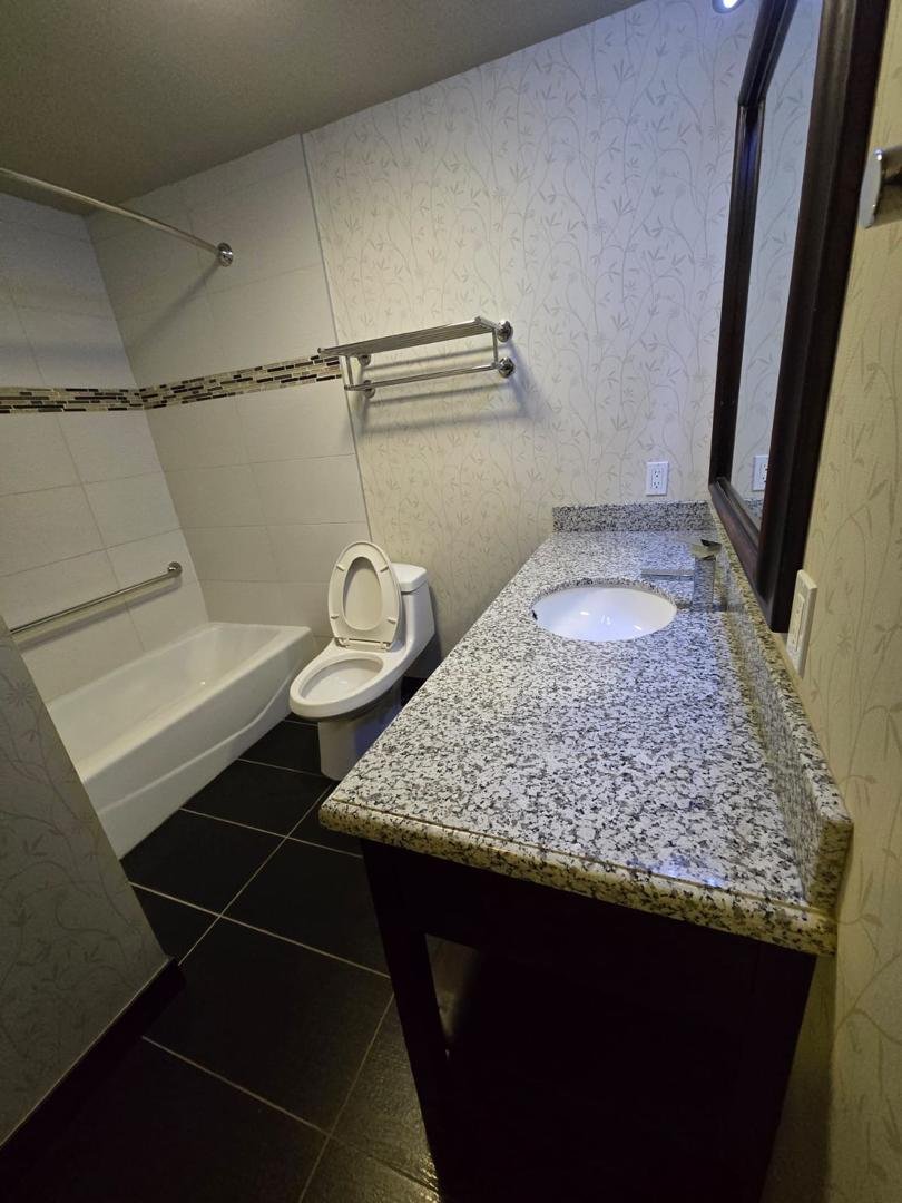Hotel bathroom vanity and bathtub after cleaning