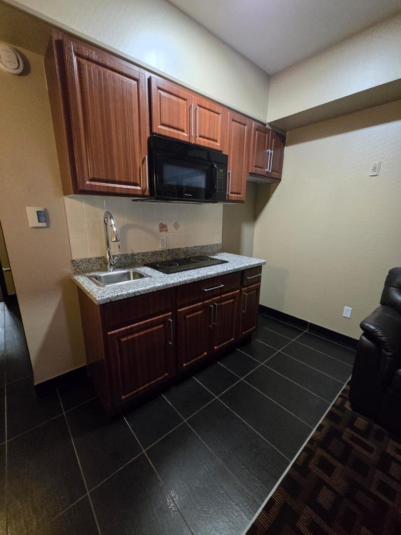 Hotel kitchenette sink and cabinets after cleaning